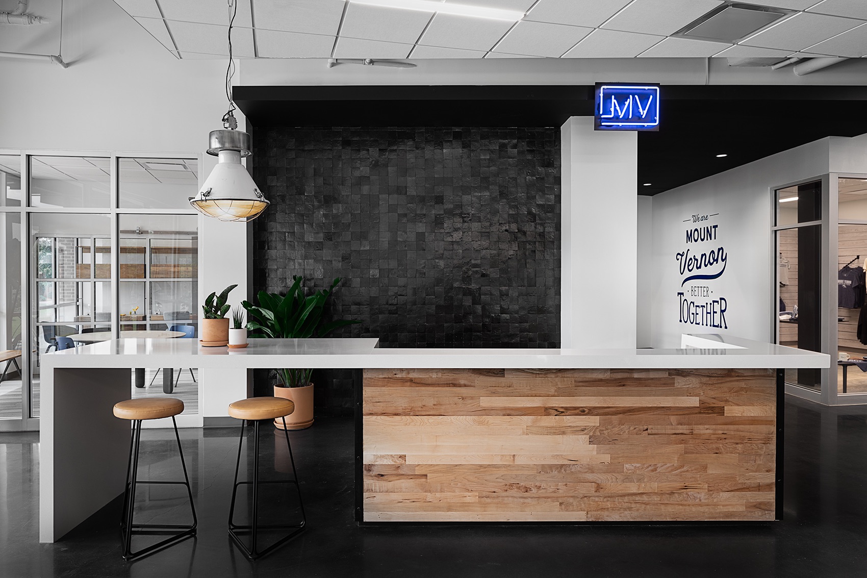 The Bridge entrance hub with neon MV sign and hand-painted We are Mount Vernon Better Together
